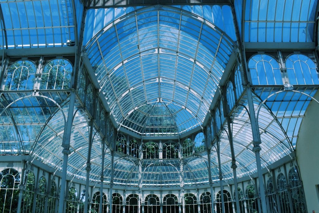 Elegant architecture of the glass-roofed Palacio de Cristal in Madrid, Spain showcasing its intricate design.